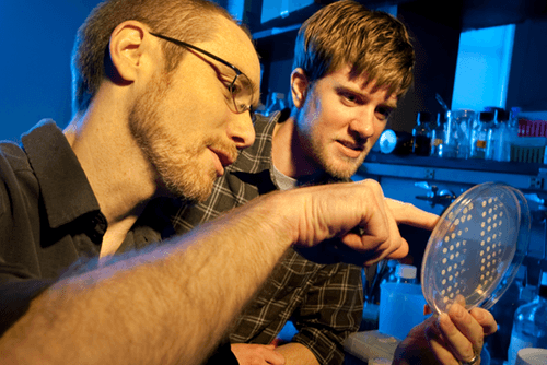 Two students look at an object