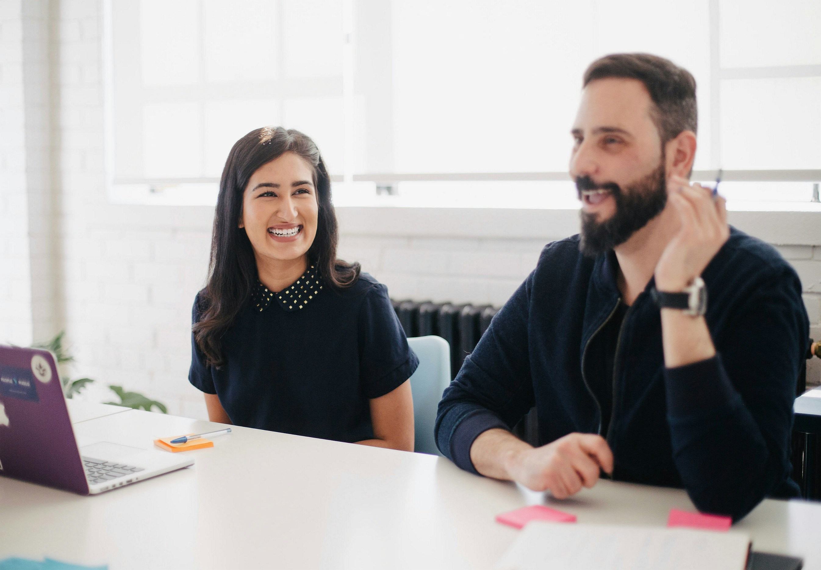 Two people at a conference table