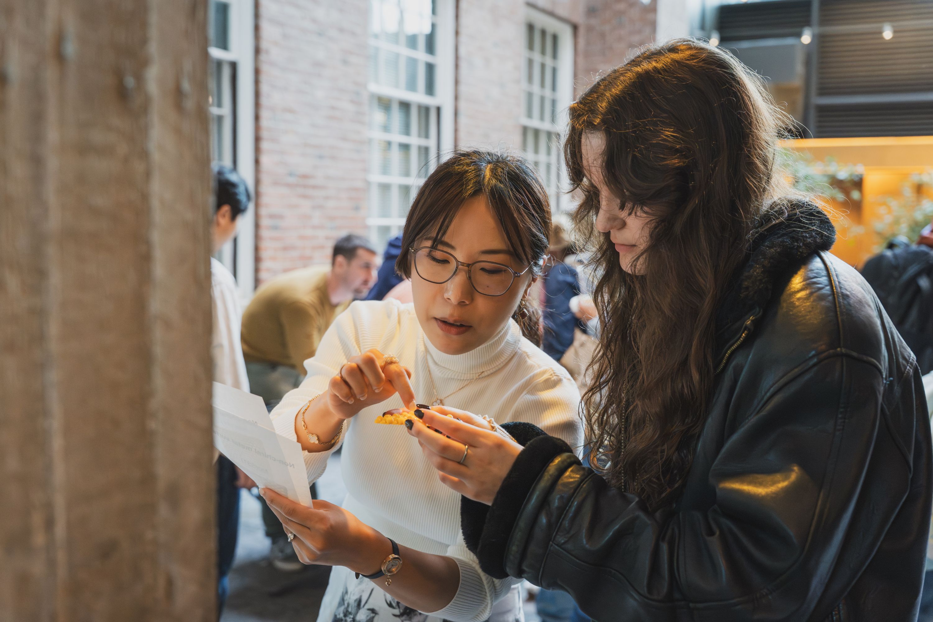 Assistant Professor of Chemistry Xin Qi discusses beta-carotene and capsaicin levels on the Scoville Scale with a student.
