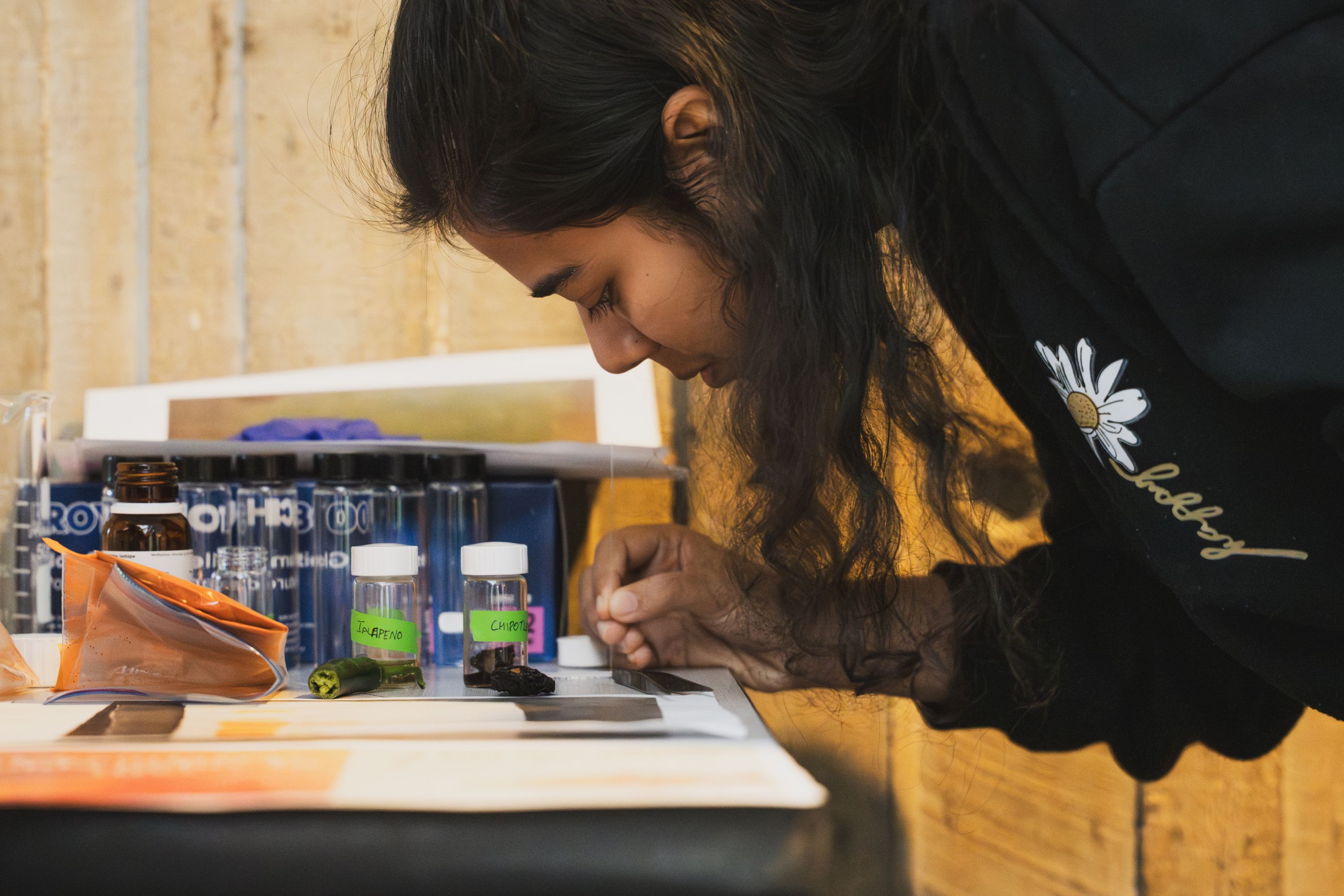 Graduate student Prajakta Kashyap from the Aprahamian Lab takes a closer look at jalapeño and chipotle peppers.