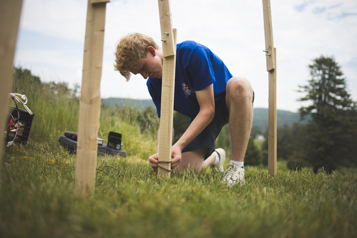 Studio art major Alden Wilcox '26 installs his Pine Cone Pavilion as part of the Pine Park Biennial.