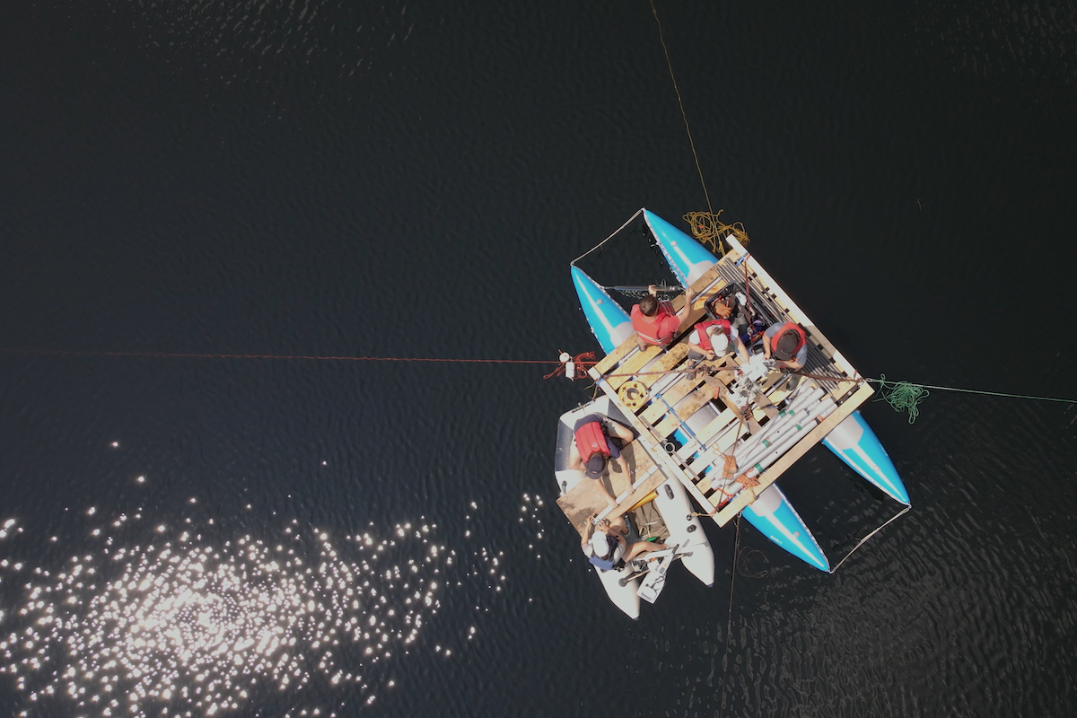  Researchers led by Professor of Earth Sciences Meredith Kelly dig for sediments in New Hampshire's Sky Pond (Photo by Northwest Sound Mixer)
