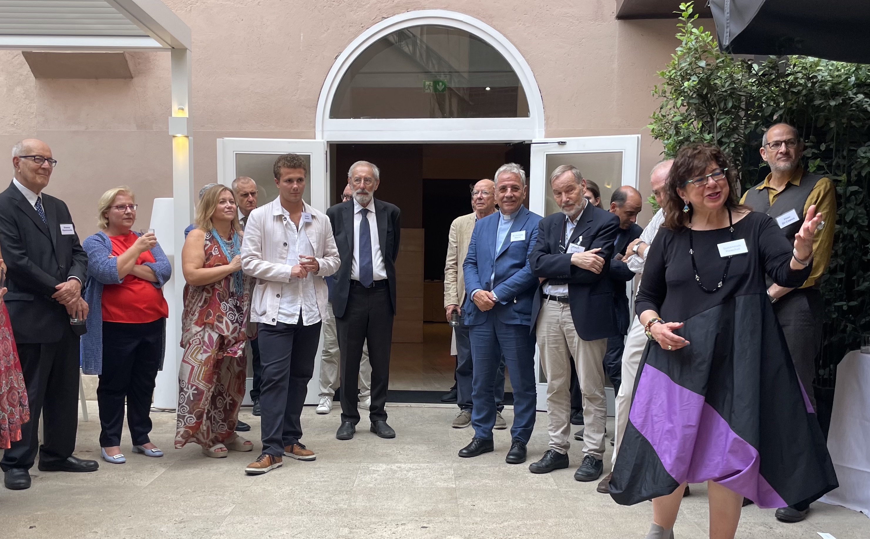 Jewish Studies Professor Susannah Heschel (right) welcomes guests to a reception at Rome's Hotel Indigo.