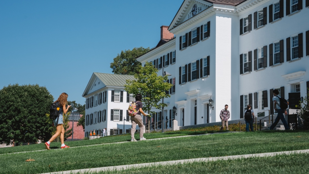 Students entering white building
