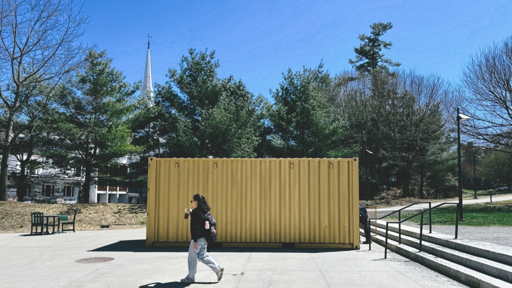 Student walks by shipping container