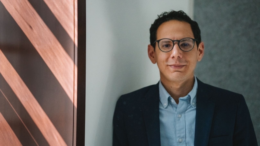 Man wearing glasses and collared shirt.