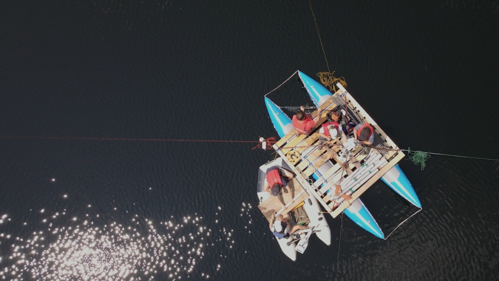  Researchers led by Professor of Earth Sciences Meredith Kelly dig for sediments in New Hampshire's Sky Pond (Photo by Northwest Sound Mixer)