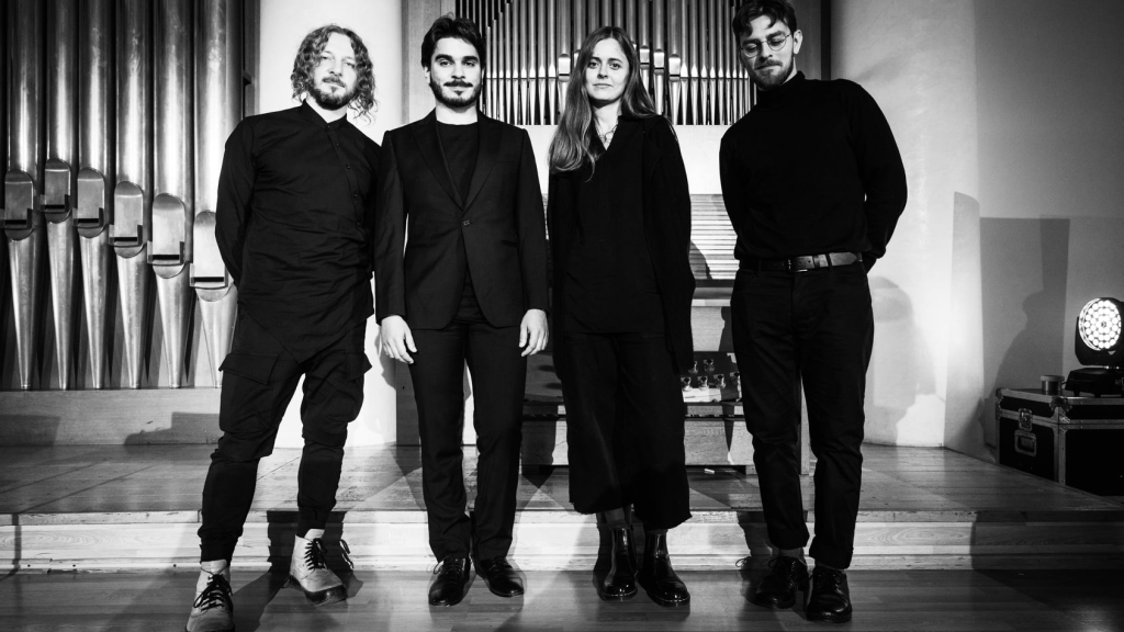 From left, Maxim Kolomiiets, Albert Saprykin, Veronika Yadukha, and Boris Loginov attend the premiere of the concert inspired by the novel Amadoka in 2021 at Ukraine's Khmelnytsky Regional Philharmonic Hall